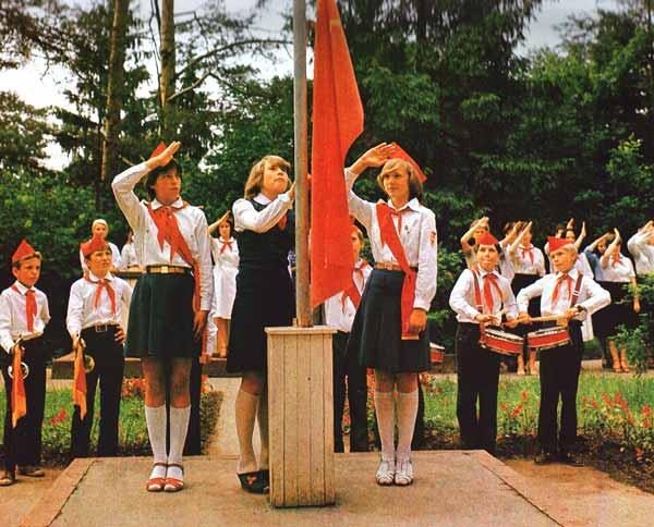 Soviet Pioneers, giving the traditional salute, in a ceremony.